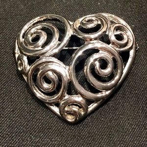 Heart brooch.  Silver color.  Attractive and contemporary swirl pattern.